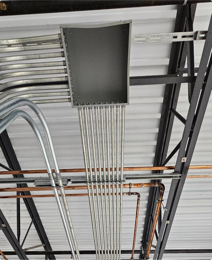 Professional conduit bending and raceway installation for industrial facility by T-TECH Power.